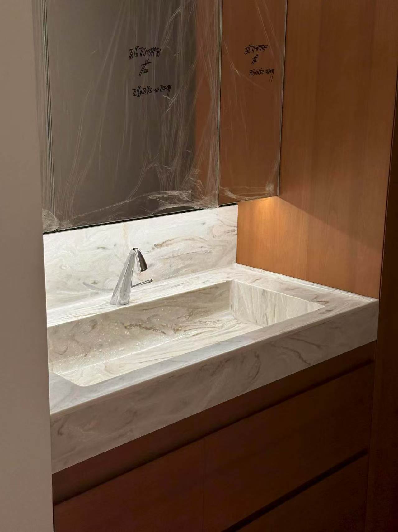 Close-up of seamless Corian bathroom vanity basin with wall-mounted tap in Singapore