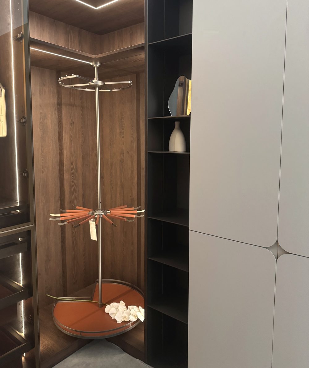 Walk-in wardrobe corner with rotating accessory carousel and lit interior at the CASAWAVE Woodlands showroom